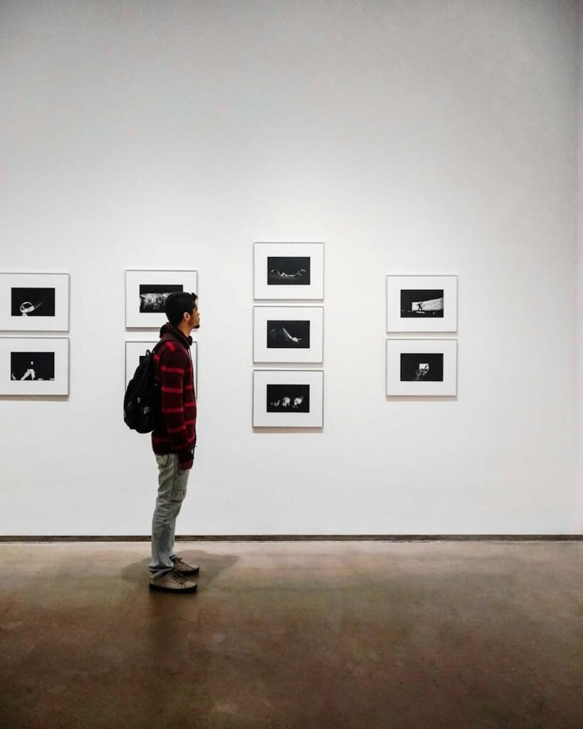 Man Standing Beside White Painted Wall