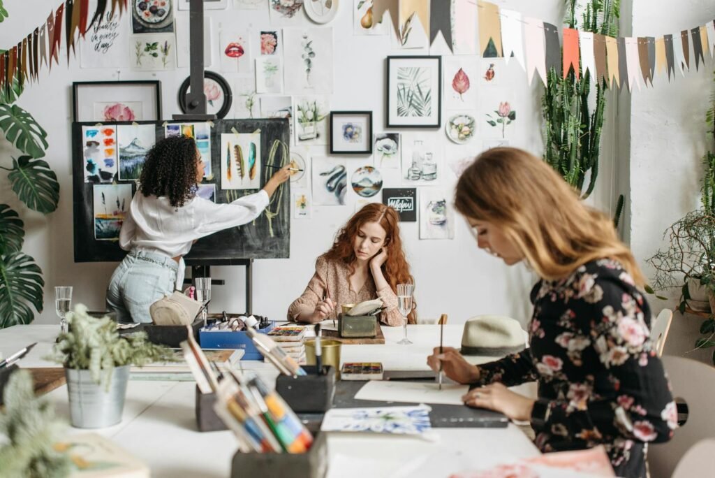 Women using Paintbrush while Making an Artwork