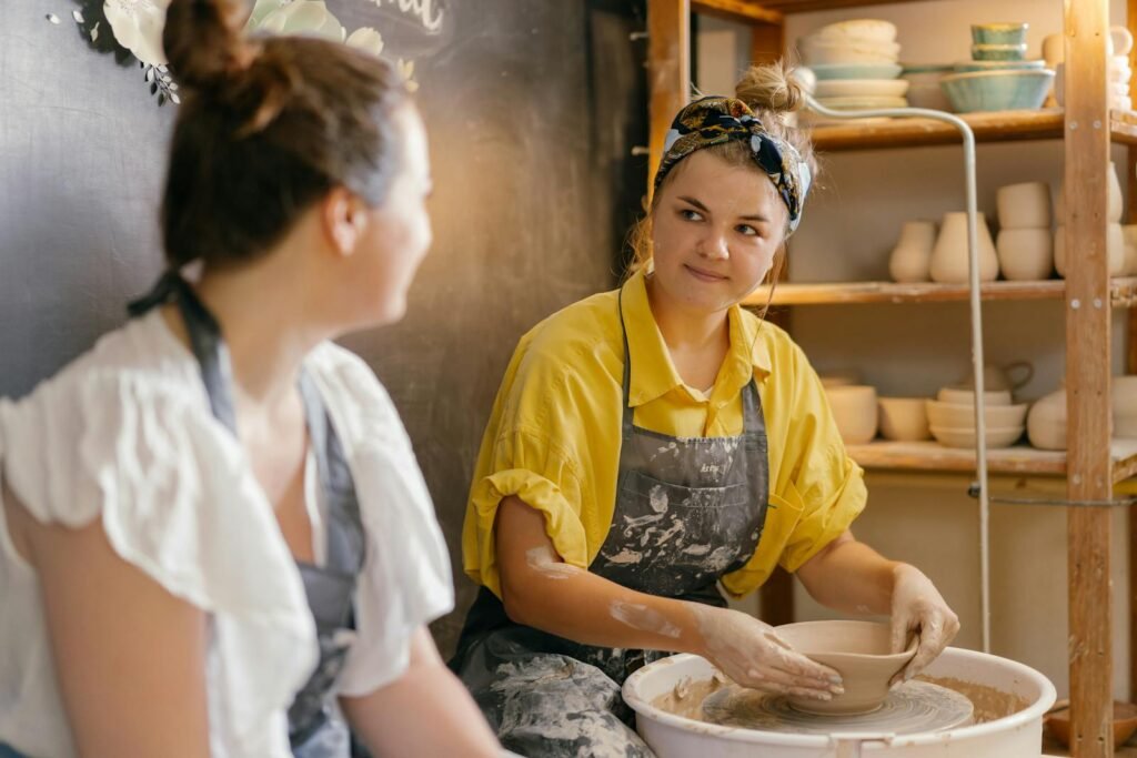 Women Looking at Each Other in Potter Workshop