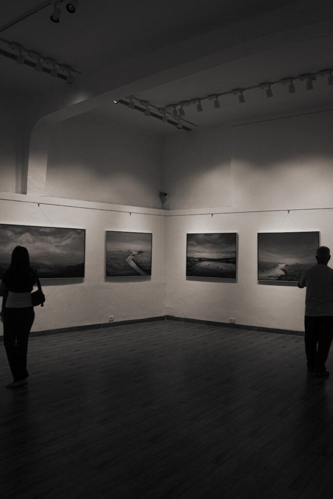 People view art in a gallery setting.